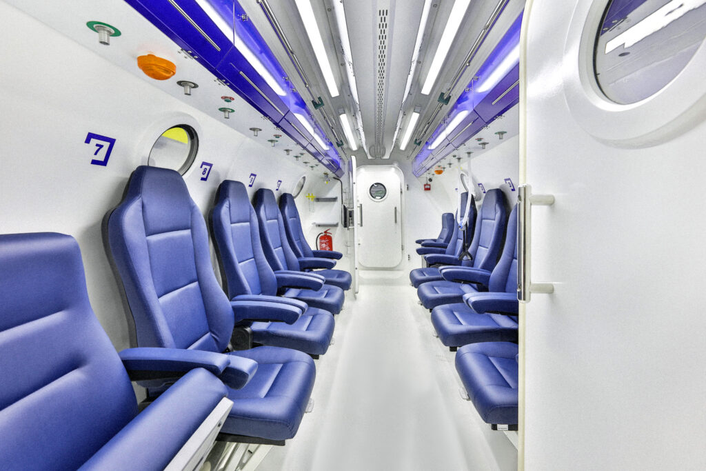 Multiplace hyperbaric chamber interior with blue seats